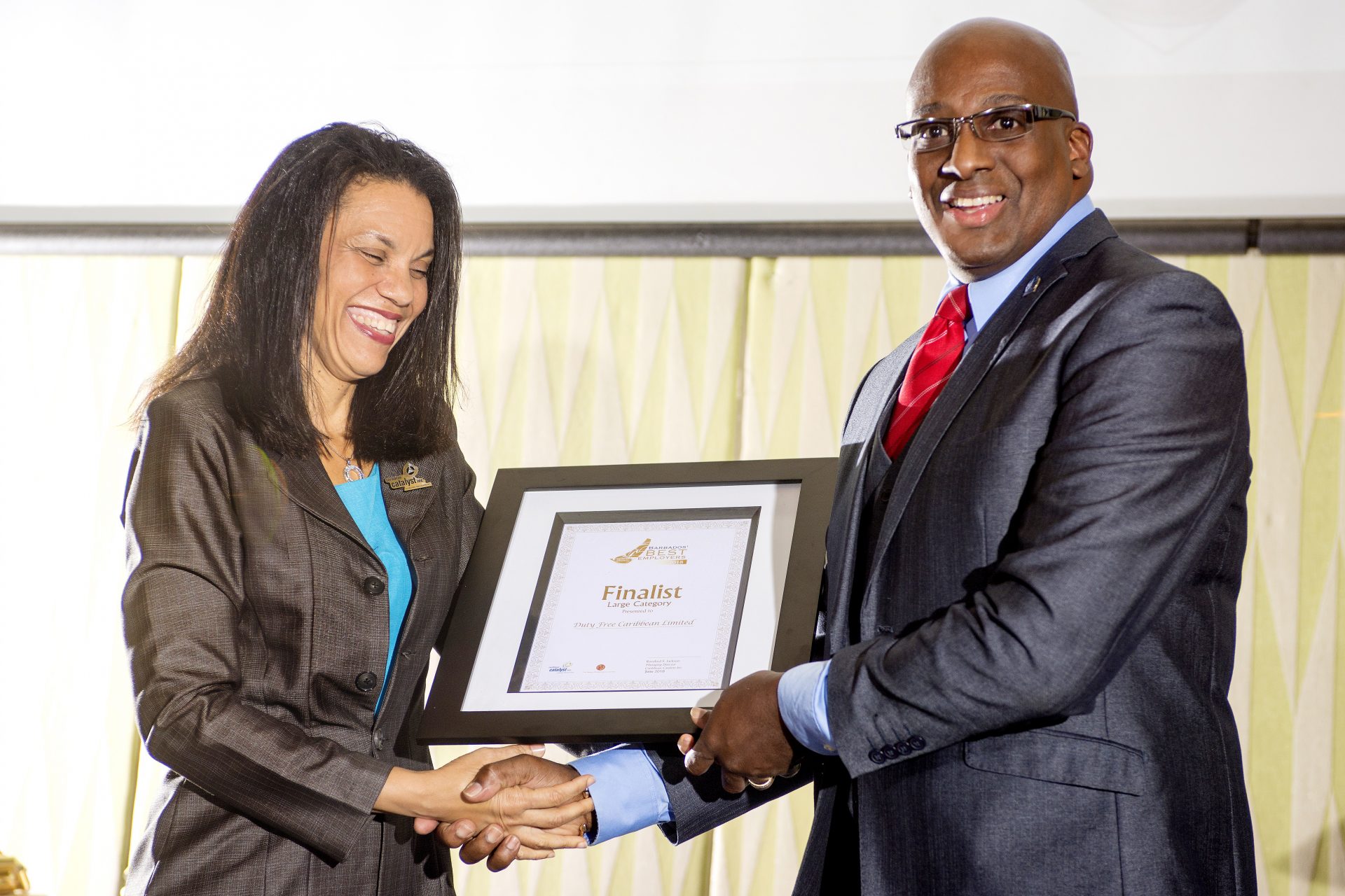 Laura presenting Mark Thornhill at Duty Free Caribbean with a Certificate as one of the Finalist in the Large category