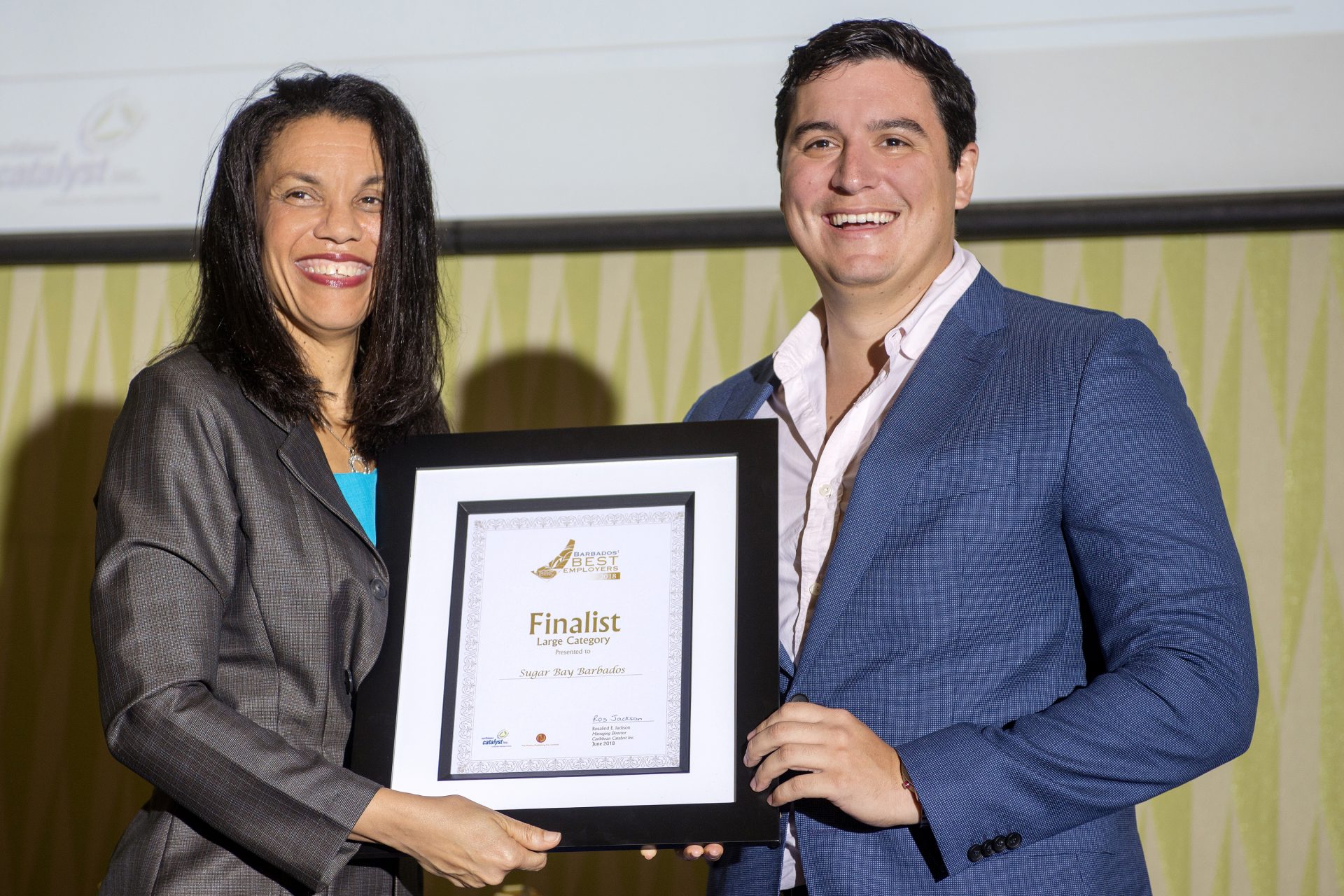Laura presenting Morgan Seale at Sugar Bay with a Certificate as one of the Finalist in the Large category